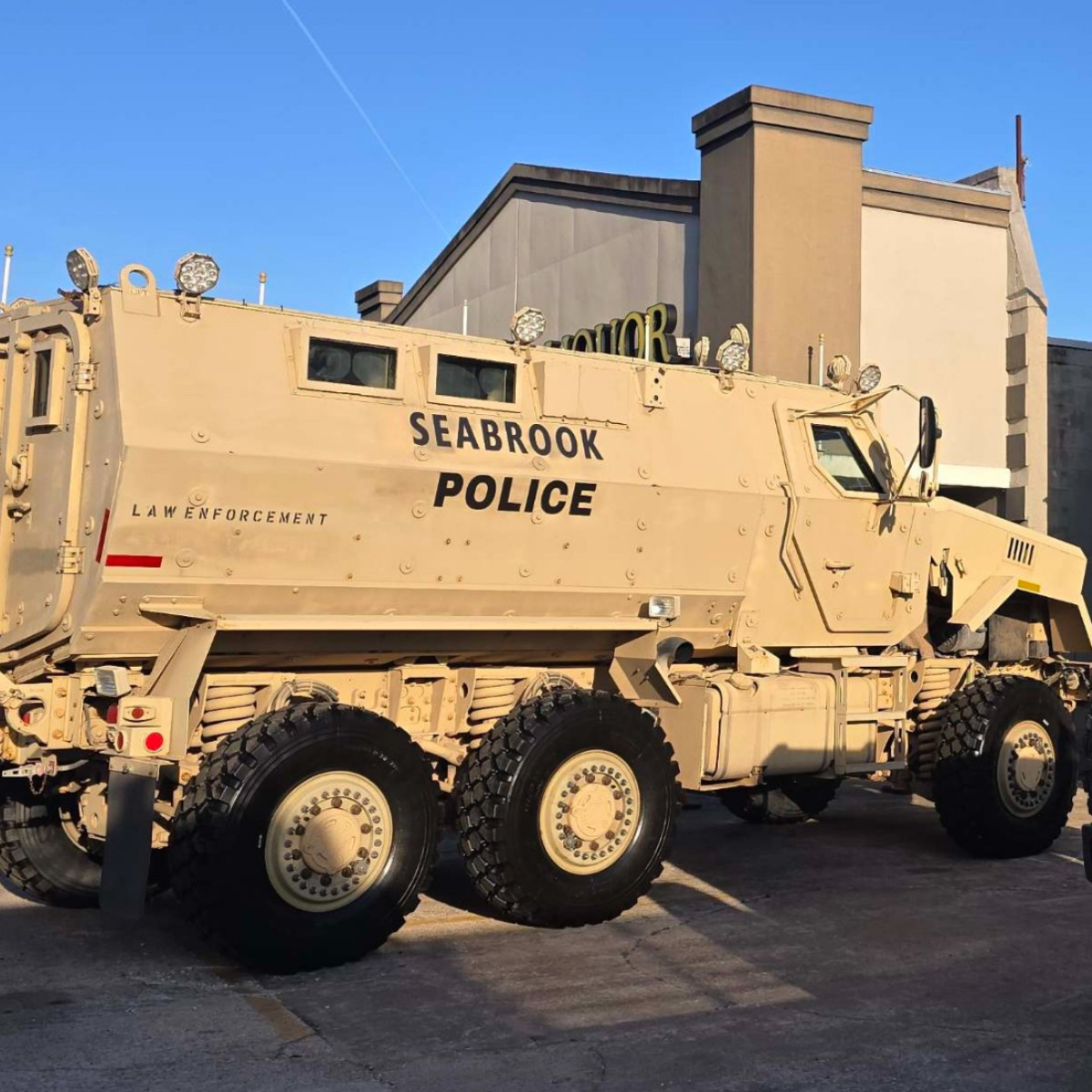 A large tan armored vehicle marked \